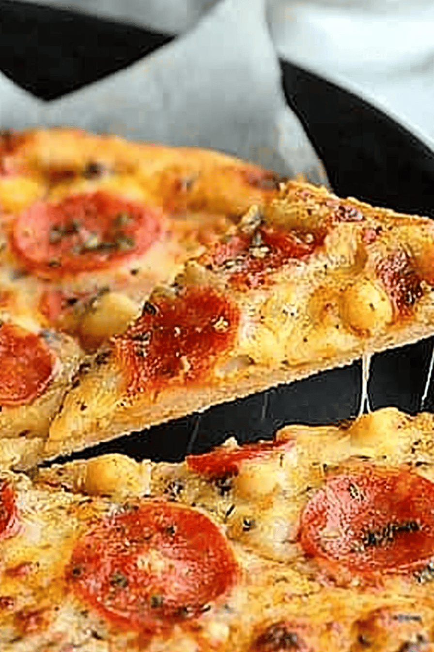 Chickpea Crust Pizza slice on plate showing perfect texture and swirl pattern