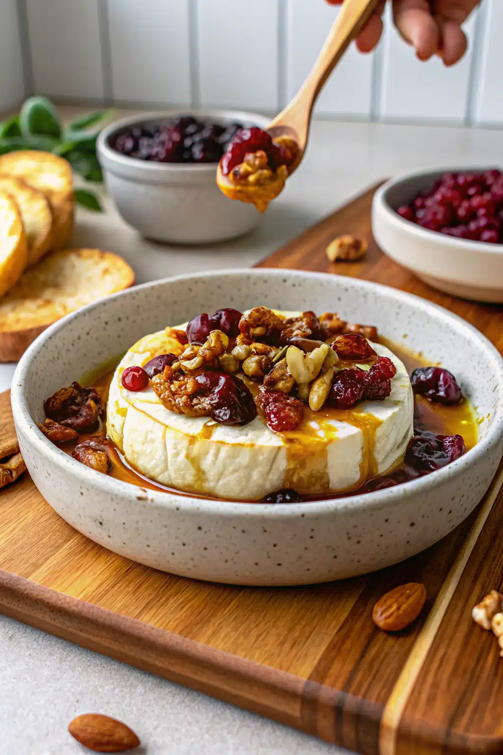 Baked Brie with Honey and Cranberry Sauce beautifully presented from an overhead angle