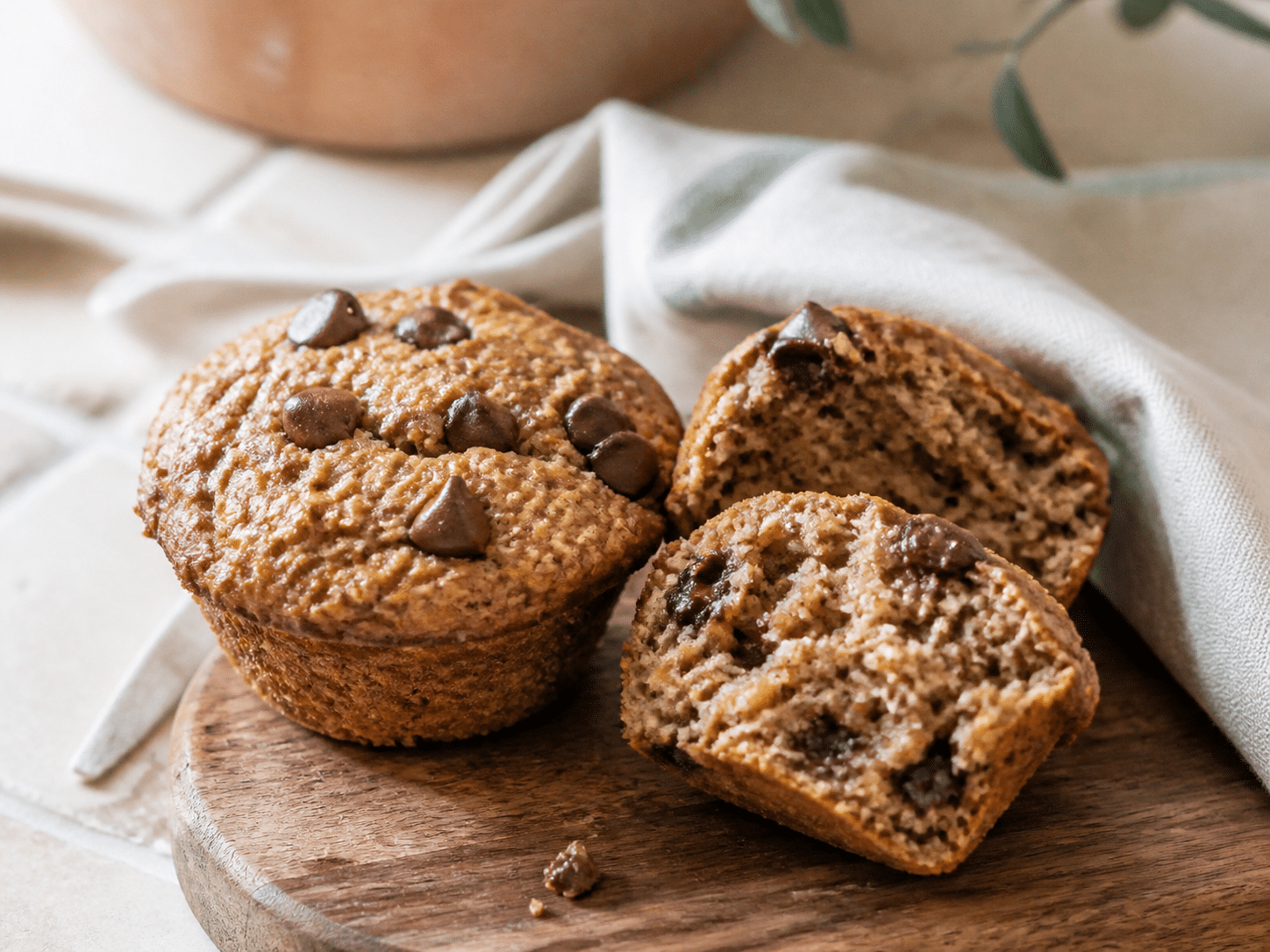 banana muffins split open to show their moist oat and banana crumb