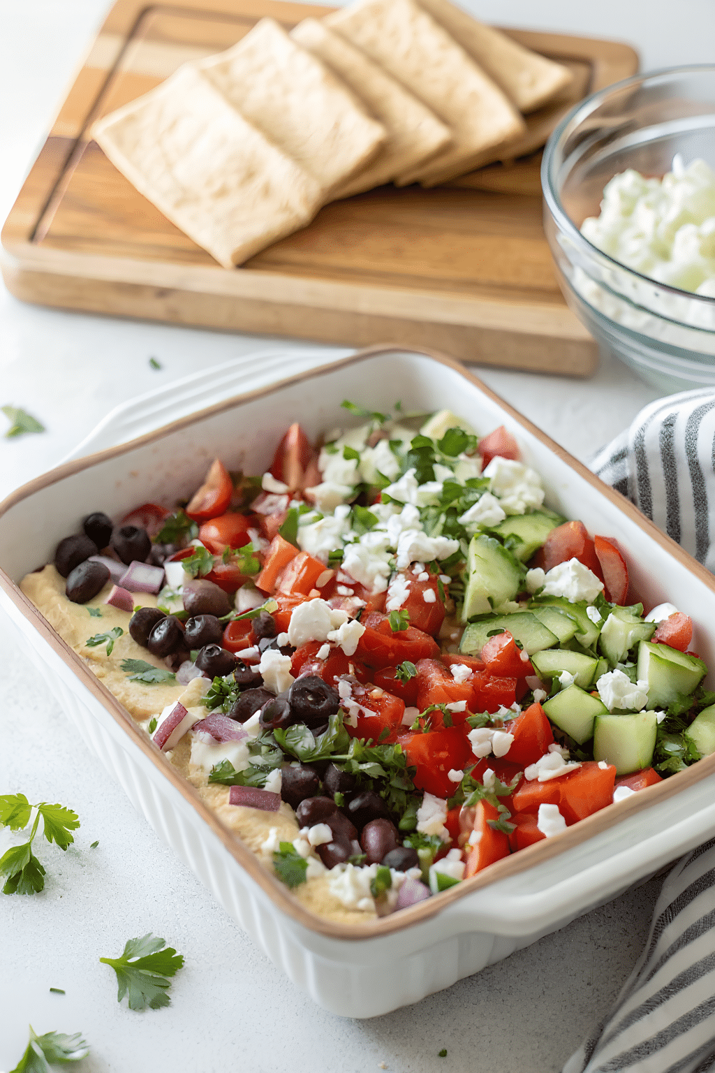 Greek layer dip with hummus vegetables and feta