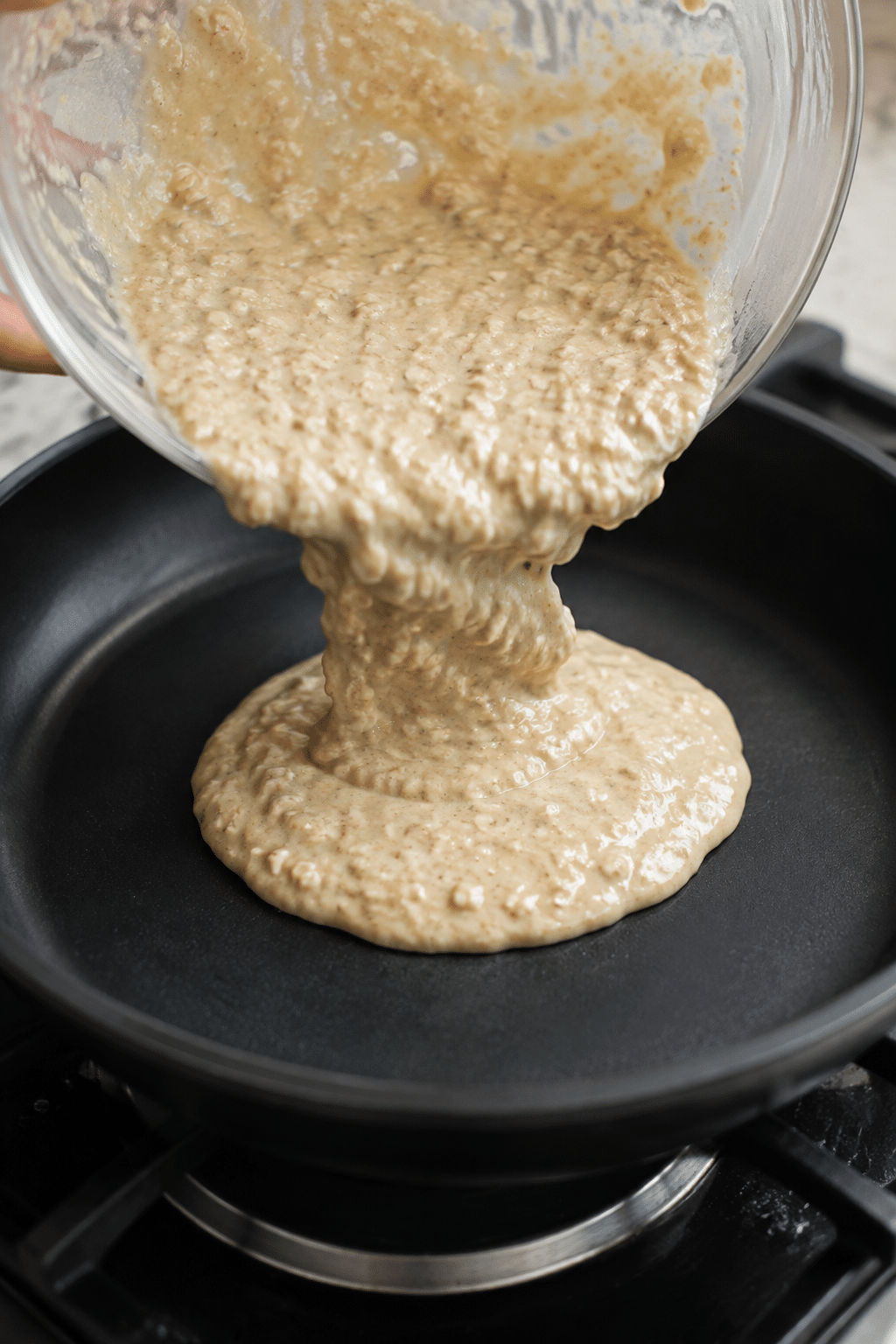 banana oatmeal pancake batter poured into skillet