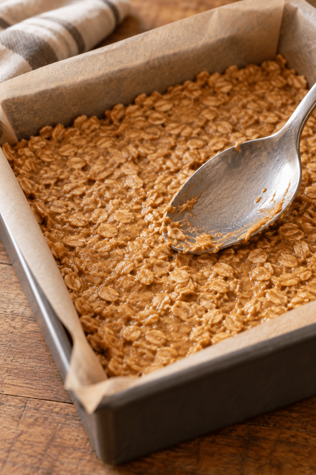 pressing no bake snack bars into a lined pan